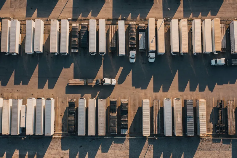 An aerial view of flatbeds, dry vans, refrigerated trailers and containers in a freight yard